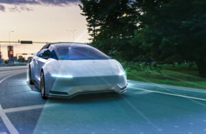 A vehicle driving on a road using scanners to see the road.