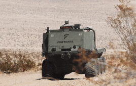 A Forterra truck driving through a desert.