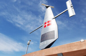 One of Saildrone's uncrewed surface vehicles (USVs) with the Denmark flag on it.